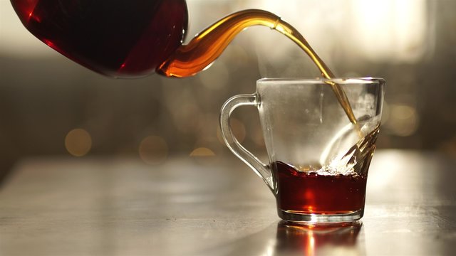 Cup of tea and mint on a wooden background