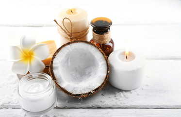 Spa coconut products on light wooden background