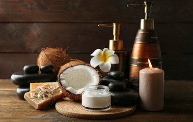 Spa coconut products on dark wooden background