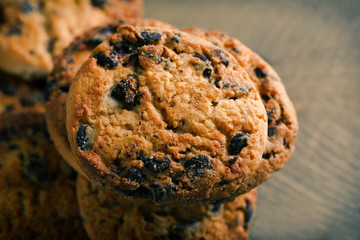 Cookies with chocolate crumbs on wooden table, close up