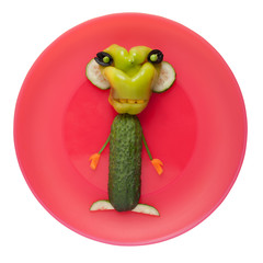 Funny vegetable monster on pink plate