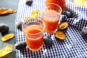 Plum Juice in a glasses with fresh fruits
