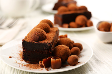 Slices of chocolate cake with a truffle on plate closeup