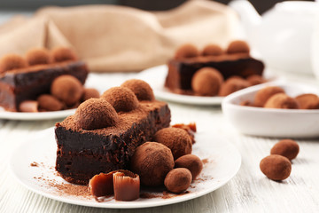 Slices of chocolate cake with a truffle on plate closeup