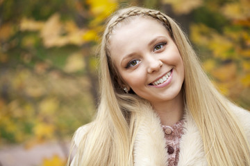 Young beautiful girl in a leather sheepskin coat