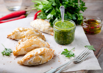 Empanadas with meat and green chili sauce. Traditional mexican dish.