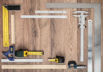 Measuring tools on wooden background.