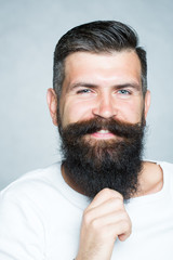 Fototapeta premium Grey-haired man pulling beard