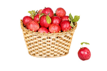 Fototapeta na wymiar Basket of ripe red apples with green leaves isolated on white