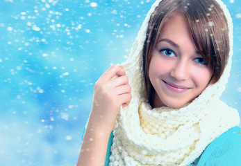 Winter portrait of a beautiful young smiling girl.
