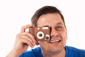 A man photographed with a camera made of chocolate - isolated