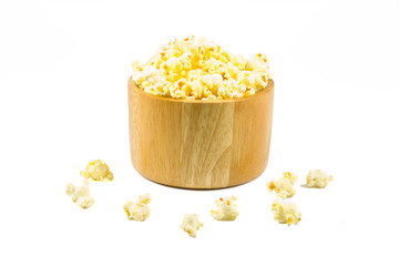 Popcorn in a wooden bowl on white isolated background