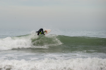 Surfer hitting the lip of the wave with a lot of speed.