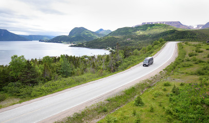 Motorhome on a mountain road at Gros Morne National Park, Newfoundland, Canada.  Tablelands in the...