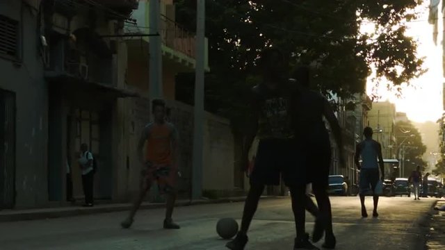 Boys kicking soccer on the old Havana street