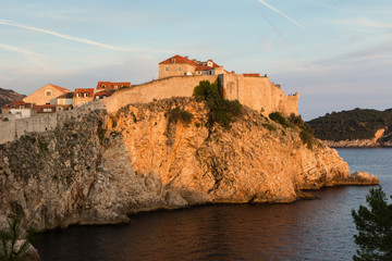 Fototapeta na wymiar City Walls in Dubrovnik, Croatia, colored orange by sunset.