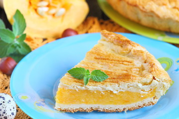 A pumpkin pie on table