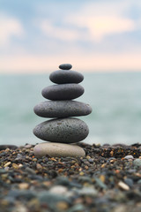 Fototapeta na wymiar Stupa made of sea pebble on a seashore.