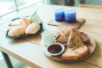 Honey toasted on wooden plate decoration in vintage style.
