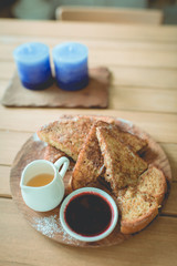 Honey toasted on wooden plate decoration in vintage style.