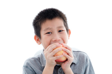 Asian boy eating a red apple isolated on white background