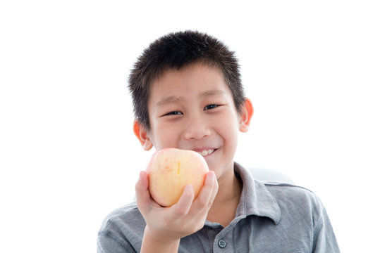 Asian Boy Eating A Red Apple Isolated On White Background