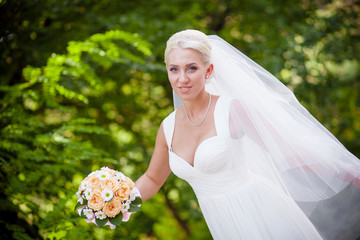 bride in white dress holding a wedding bouquet