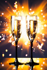 champagne glass against sparkler background