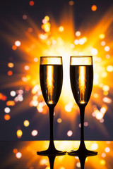 champagne glass against sparkler background