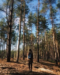 girl is standing in the forest