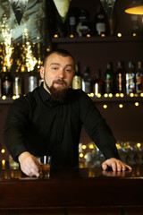 Portrait of handsome bartender at  work