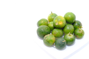 Calamondin or calamansi lime on a white background.
