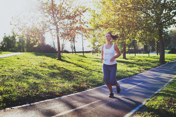 workout, young woman running in the park