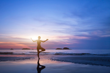 yoga, silhouette of woman on the beach