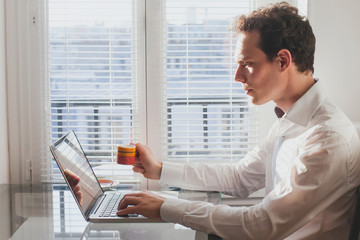 businessman reading emails in the office with cup of coffee