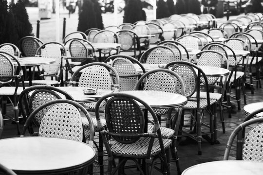 Fototapeta vintage street cafe in Paris, black and white photo of wicker chairs and tables
