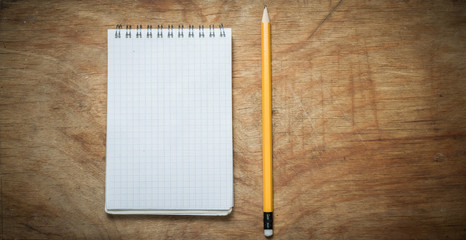 Pencil and Notepad on an old rustic table.