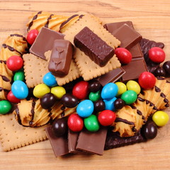 A lot of sweets on wooden surface, unhealthy food