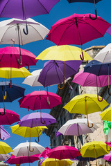 Fototapeta na wymiar Street decorated with colored umbrellas. Arles, Provence. France