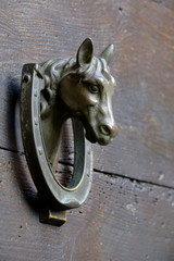 Door knocker in form of the horse head and horseshoe