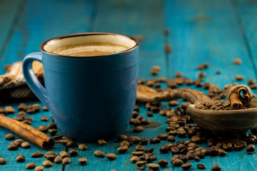 coffee Cup and beans on a blue wooden background