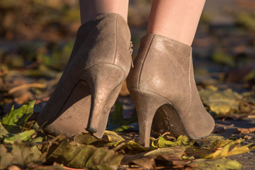 Heel of woman on the autumn leaves