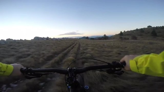 Mountain biker on trail in sunset