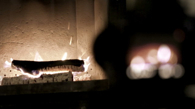 Cozy warm footage of a camera shooting fireplace in the evening