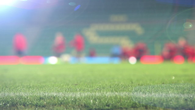 Unfocused footage of footballers (soccer-players) warming up before the match