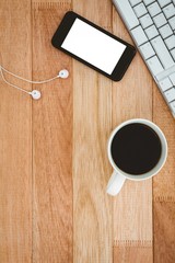 Black smartphone with cup of coffee