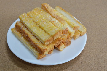 butter toasted bread topping sugar on dish
