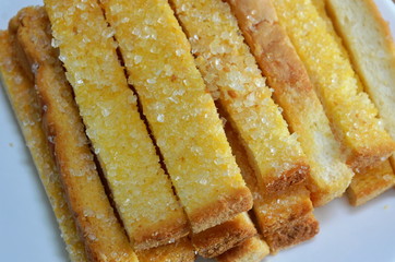 butter crispy stick bread topping sugar on dish