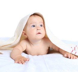 Adorable baby girl lying under blanket on a white background