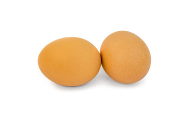 Two brown eggs isolated on white
